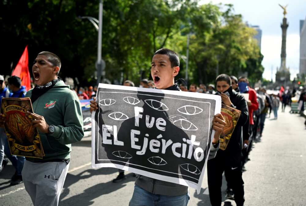 "It was the army" reads a sign carried by a protester at a march in Mexico City to demand justice for 43 students who disappeared in 2014