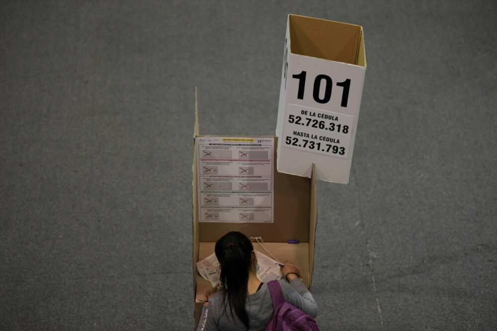 A woman votes at a polling station during parliamentary elections in Bogota on March 13, 2022