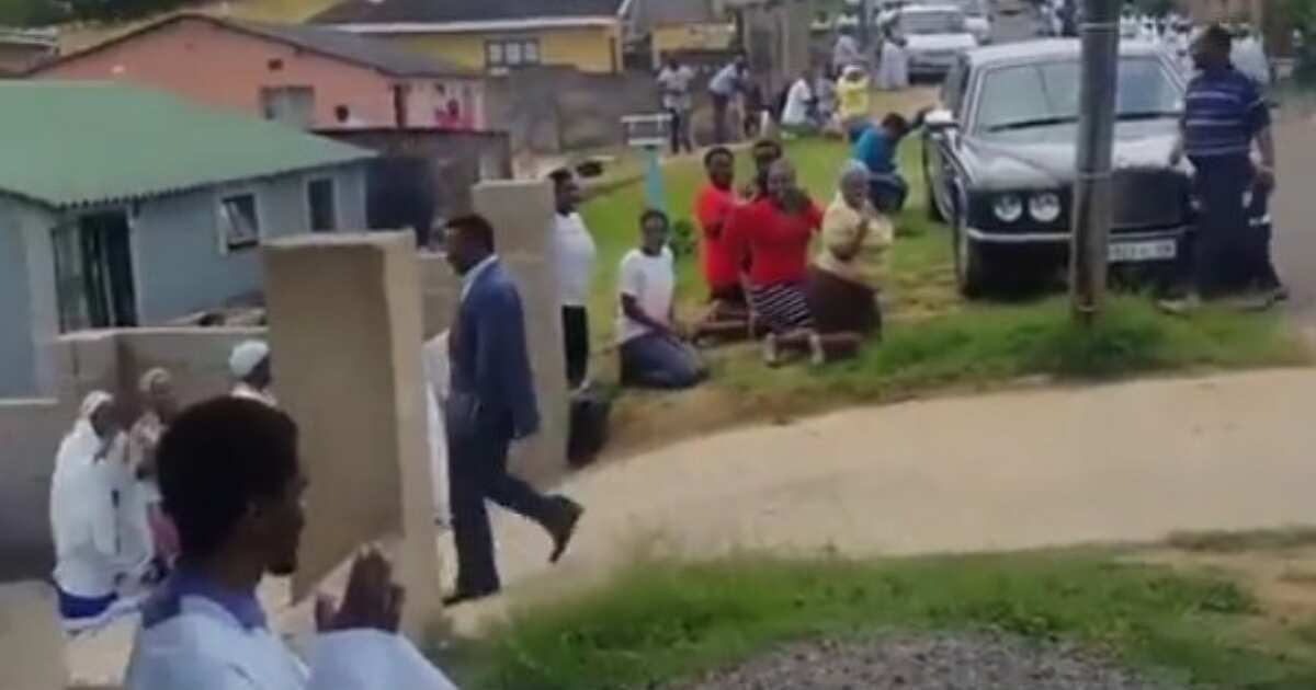 Photos and video of church members kneeling for pastor as he walks go viral