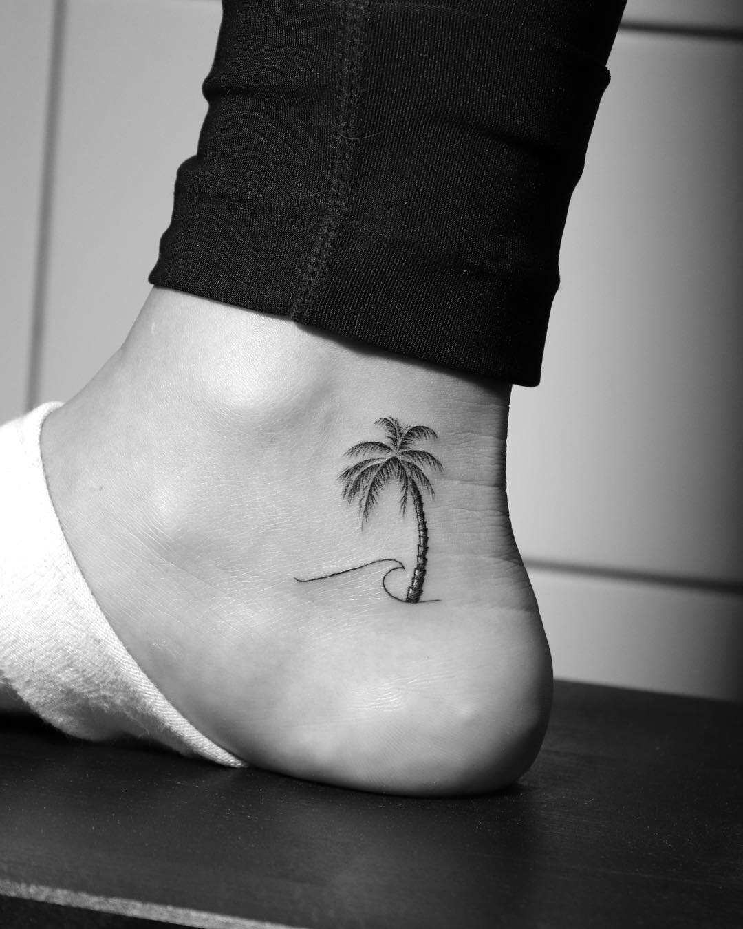 Minimalist palm tree tattoo on the ankle