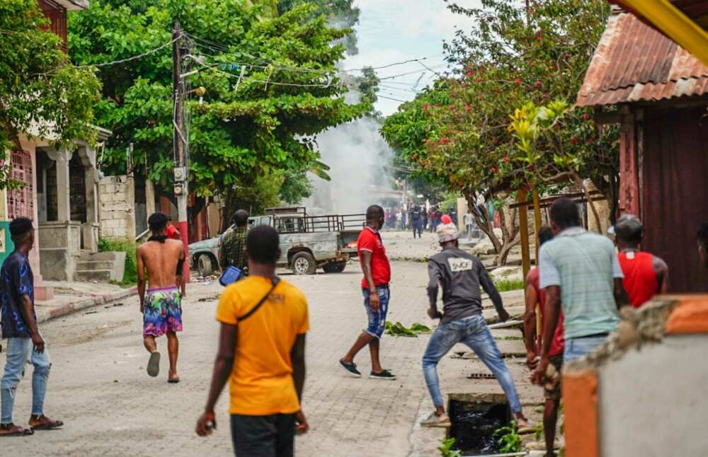Haitians throw stones at the police during a violent demonstration in August 2022; they were protesting the rising cost of living and insecurity as the country, the poorest in the Western hemisphere, is mired in gang violence and political turmoil
