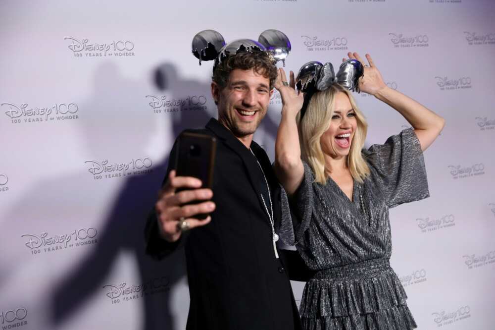 US singer and dancer Kimberly Wyatt and her husband Max Rogers arrive to attend the Disney's D100 Debut event in central London on October 27, 2022.