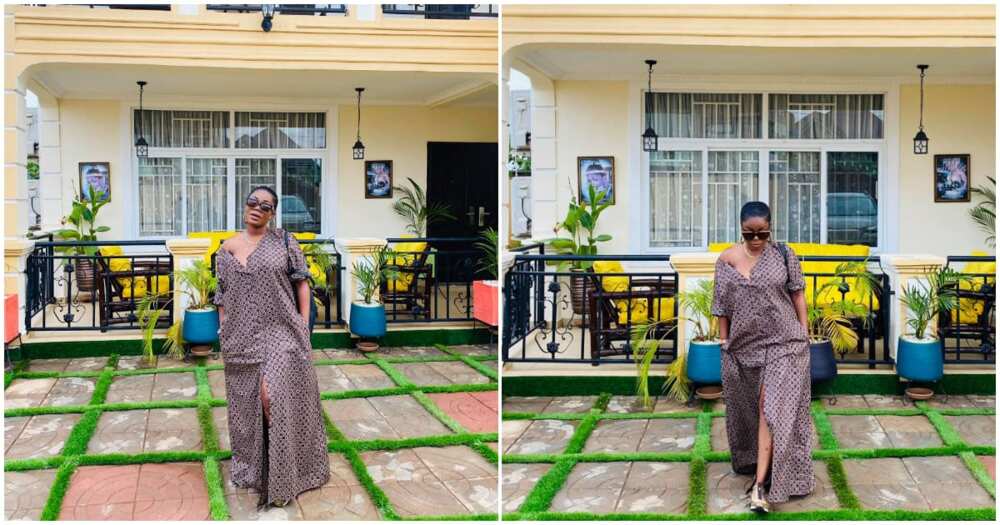 Mzbel poses infront of her mansion