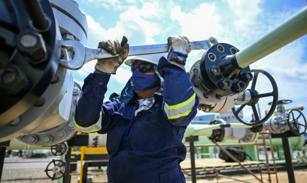 A worker fixes a pipeline at an oil facility in the town of Acacias in Colombia in February 2023