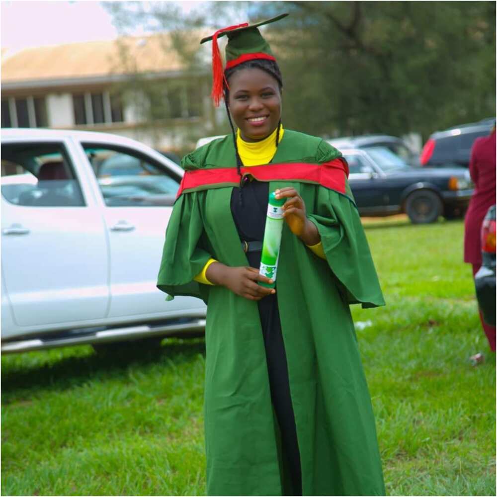 Sarah smiles in her UNN graduation gown.