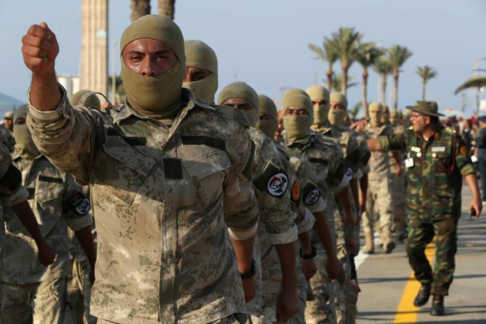 Masked Libyan soldiers take part in a military parade in the capital Tripoli on August 9