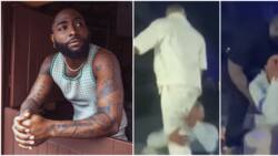 "Burna Boy for use shoe match am": Davido almost falls as fan jumps on stage, locks his legs in tight embrace