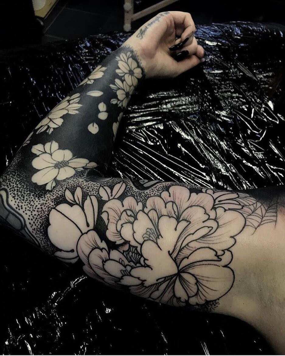 Blacked out arm tattoo