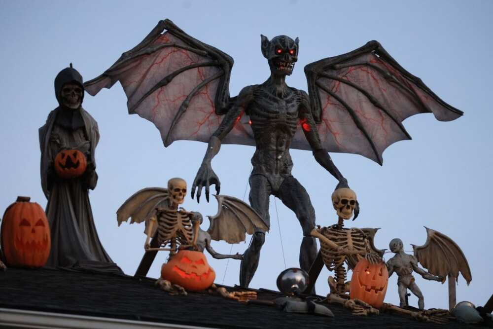 Ghouls and goblins line a roof as Halloween decorations in the Hancock Park neighborhood of Los Angeles, California.