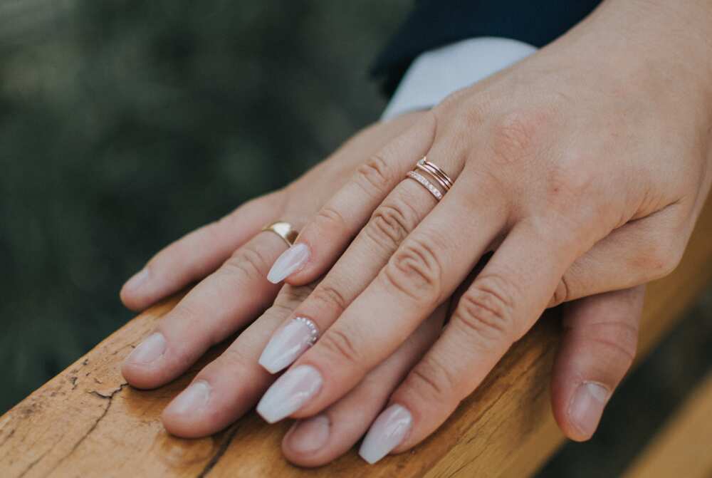 A married couple's hands in wedding rings