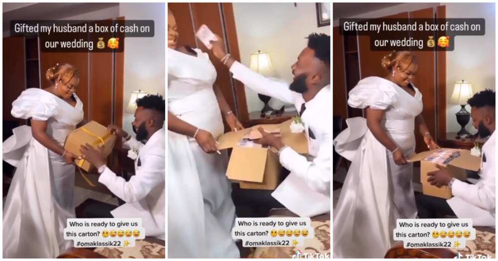 Bride gifts groom, box filled with cash, lovely couple moment on wedding day, bride gives groom box of cash