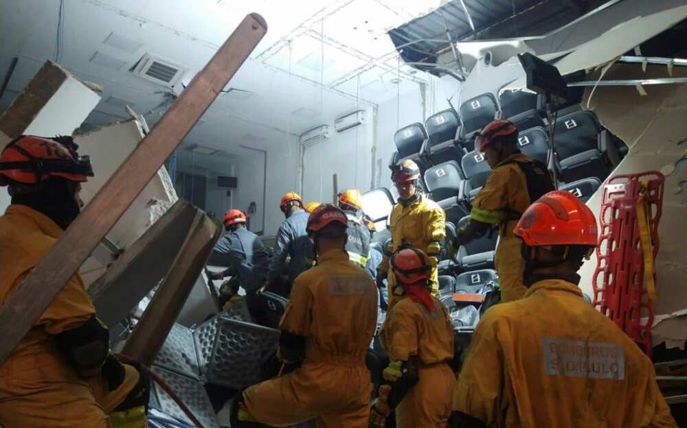 Handout picture provided by the official Twitter account of Sao Paulo fire department showing firefighters working inside a collapsed building in Itapecerica da Serra, Sao Paulo state, Brazil, on September 20, 2022