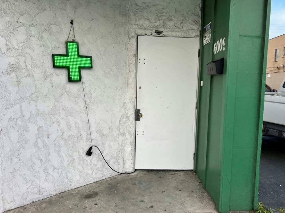 Unlicensed cannabis stores sometimes display a green cross