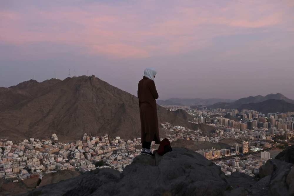 A Muslim pilgrim looks over the holy city of Mecca from atop the Jabal al-Noor or 'Mountain of Light'