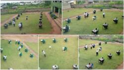 Photos show students writing exams on the field with desks spaced out, school says it's to discourage cheating