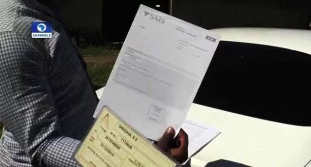 Nigerians estate agent shows documents to proof their business transactions are legal