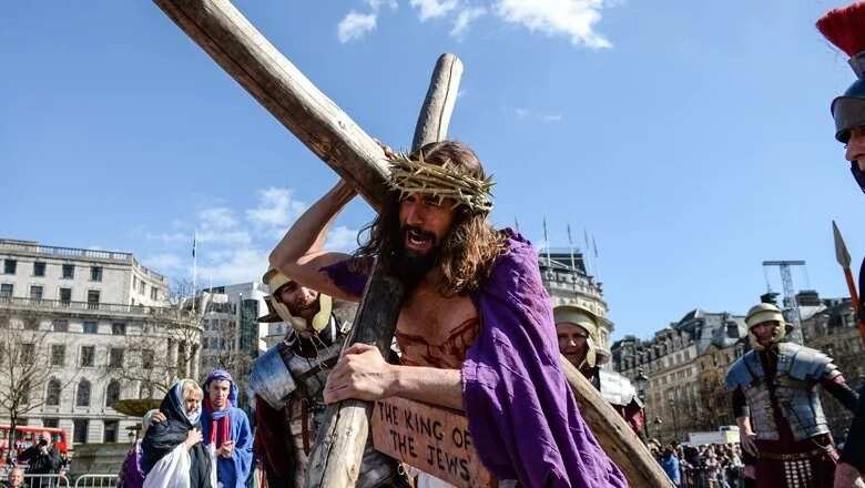 Actor James Burke-Dunsmore carries the crucifix whilst playing Jesus during The Wintershall’s The Passion of Jesus in front of crowds on Good Friday at Trafalgar Square on March 25, 2016