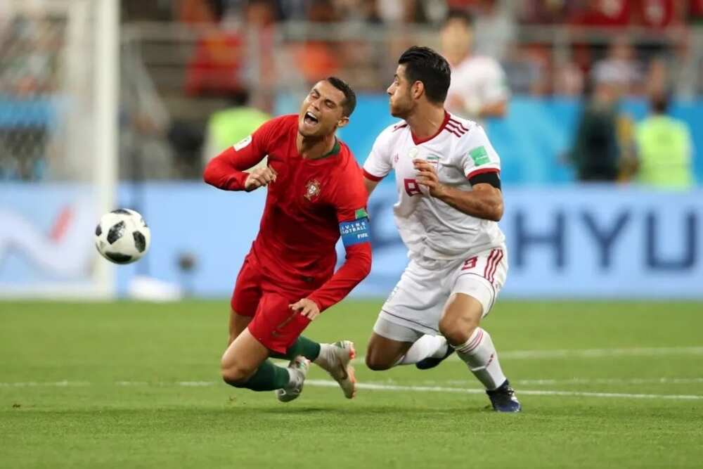 Ronaldo hacked down by an Iranian defender during the contest on Monday night as Portugal settled for a 1-1 draw with the Asians. Photo Credit: Getty Images