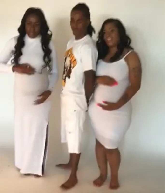 Man poses for pictures with his two pregnant girlfriends