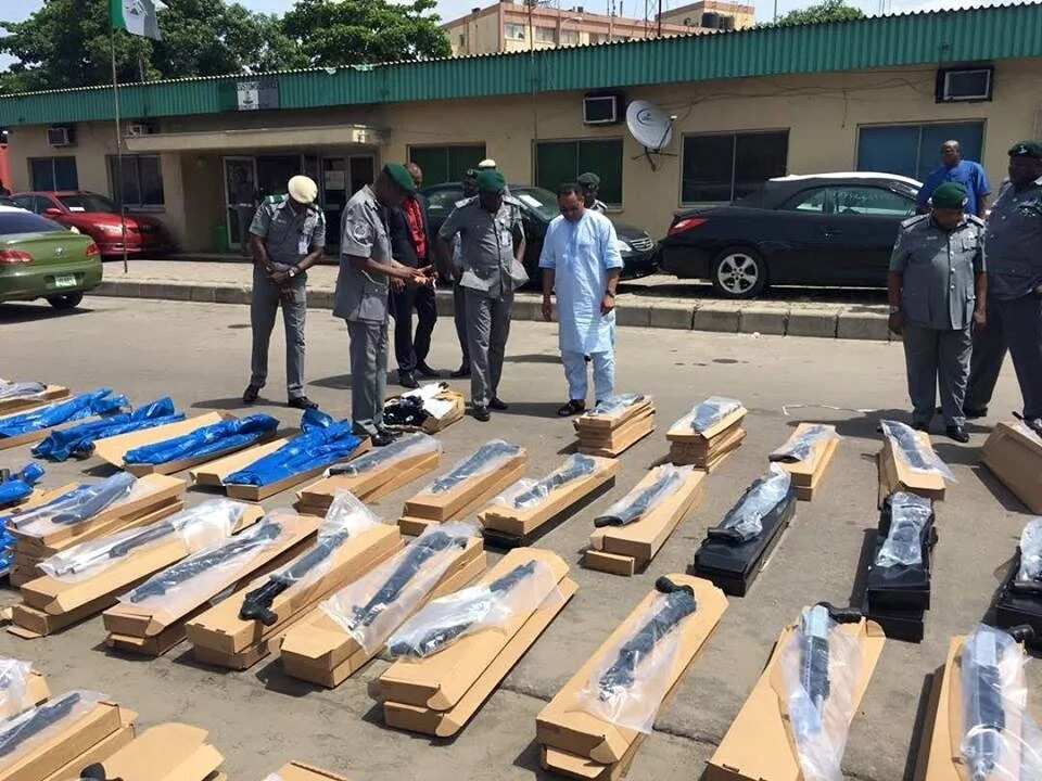 Customs officials inspecting the intercepted arms