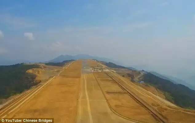 Incredible video shows Chinese workers building an airport at 5,900ft high after chopping off the top of a MOUNTAIN