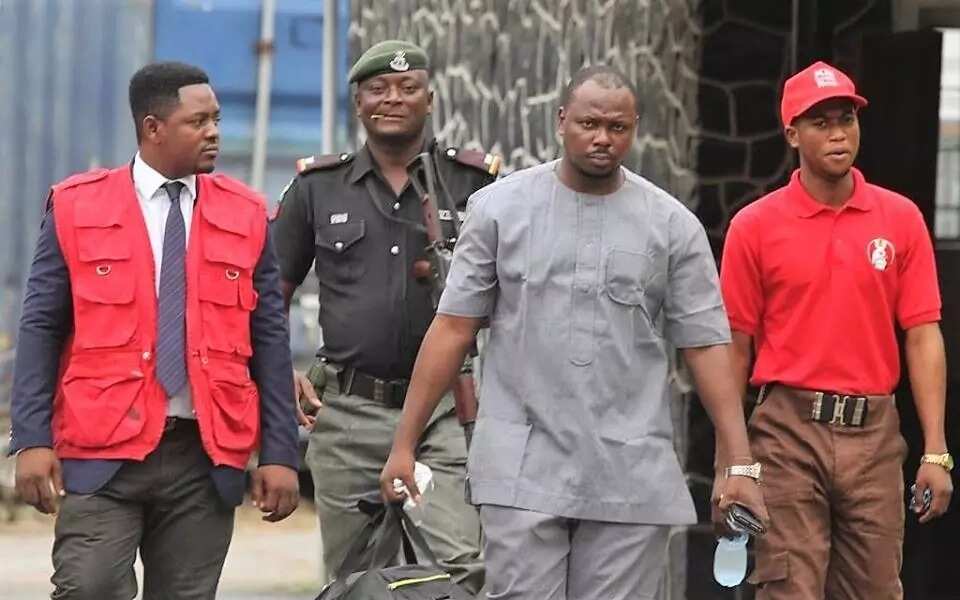 Nsa Ayi accompanied by EFCC operatives and a police officer. Photo source: EFCC