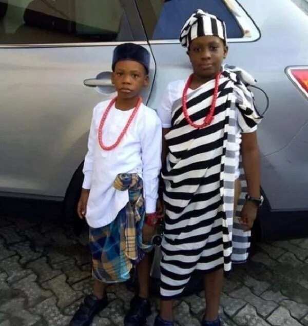 Igbo traditional attire with a wrapper in a cage or strip.