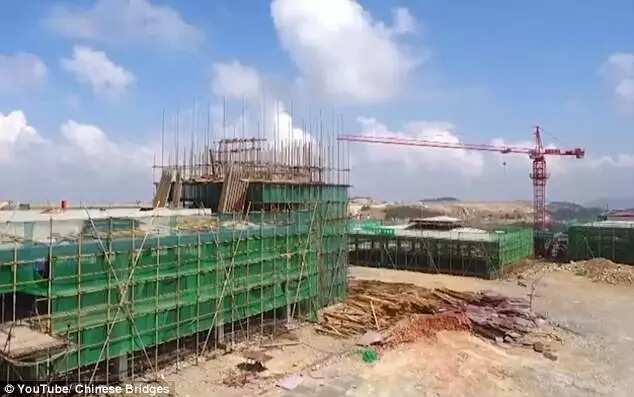 Incredible video shows Chinese workers building an airport at 5,900ft high after chopping off the top of a MOUNTAIN