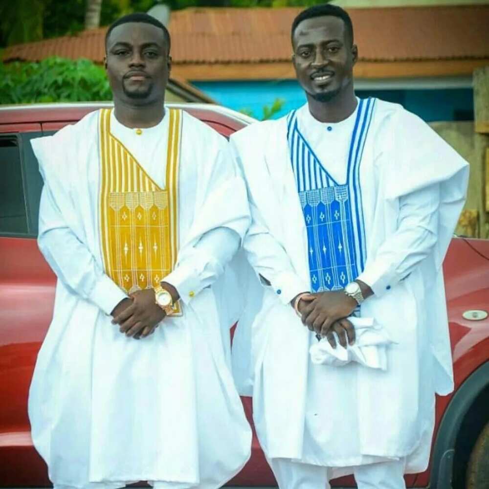 White Agbada styles for guys with blue and yellow ornaments