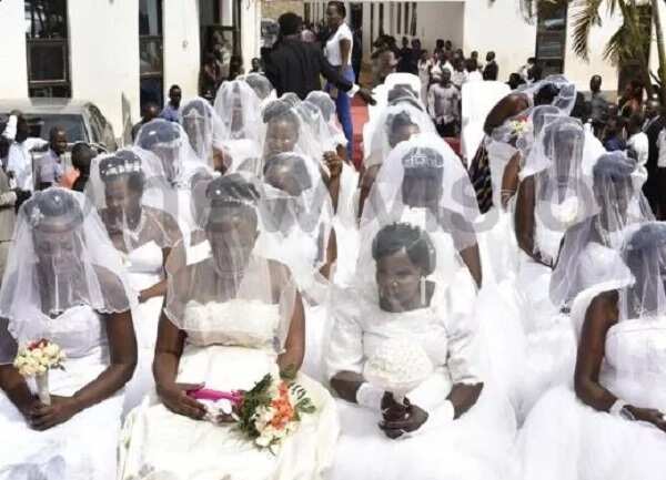 200 brides ride in a truck to their mass wedding in Uganda