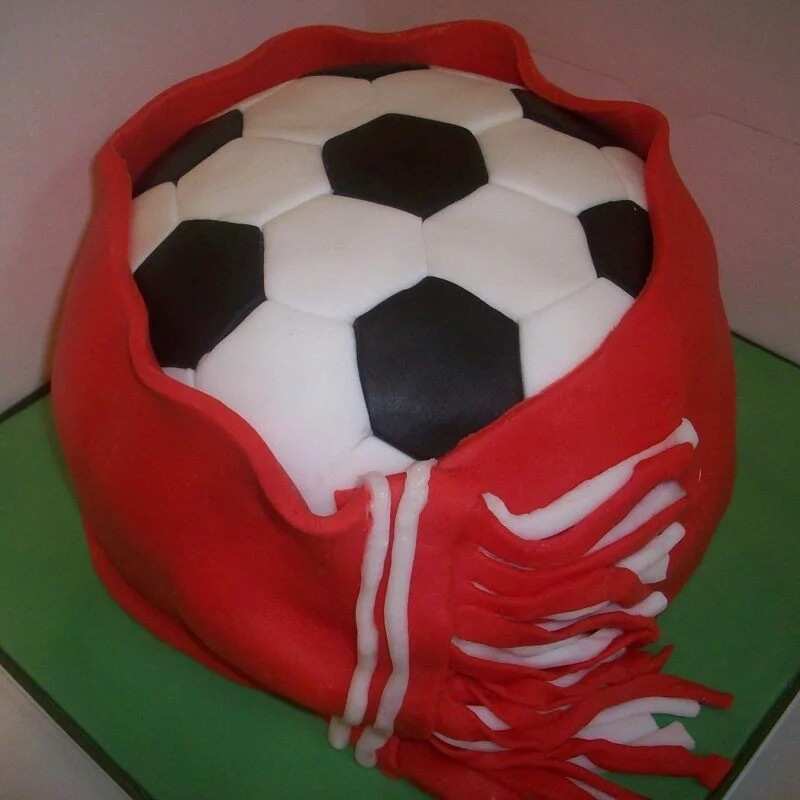 Closeup Image Of Football Themed Layered Birthday Cake Decorated On Cake  Board With Black And White Hexagonal Shaped Fondant Icing Tessellating  Tiles With Red Background Soccer Balls And Blades Of Green Grass