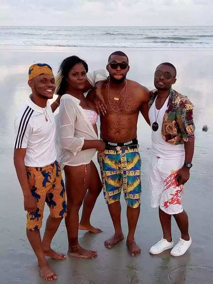 Reactions as choirmaster poses with his female friend on a beach in Akwa Ibom