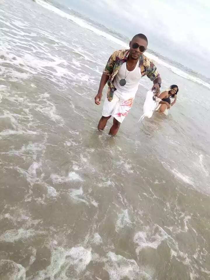 Reactions as choirmaster poses with his female friend on a beach in Akwa Ibom