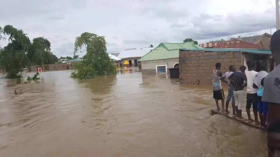 Dejected residents looked on as the flood entered their homes. Photo credits: Sahara Reporters