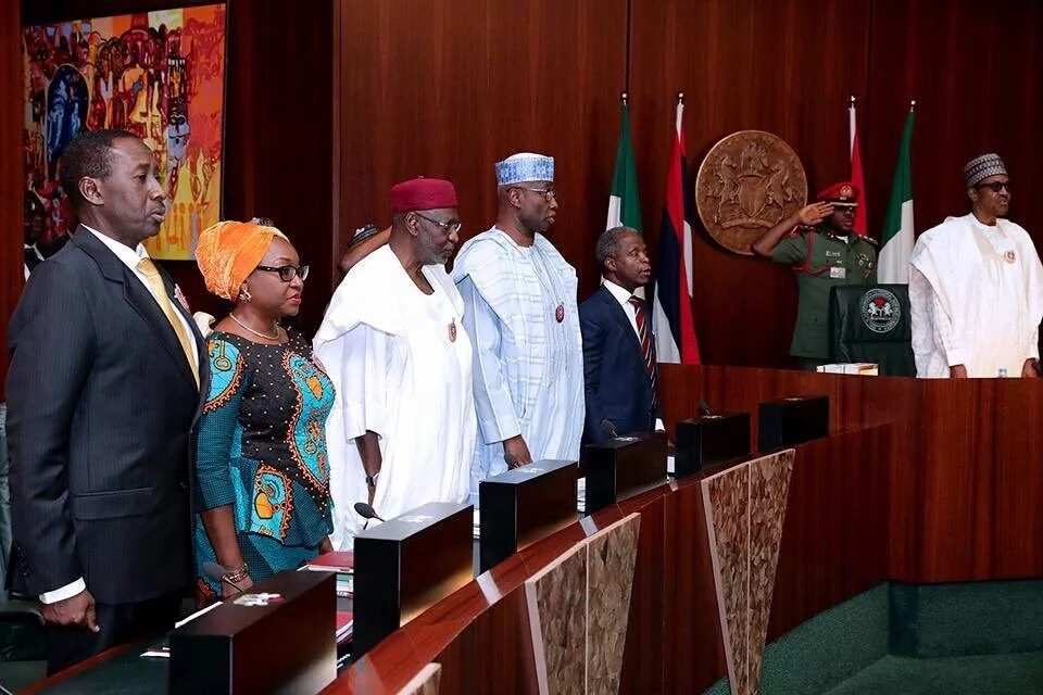 President Muhammadu Buhari and his aides praying during the FEC meeting. Photo credit: Facebook, Femi Adesina