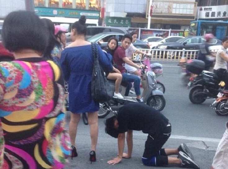 Woman drags man like a dog on the street (photos)
