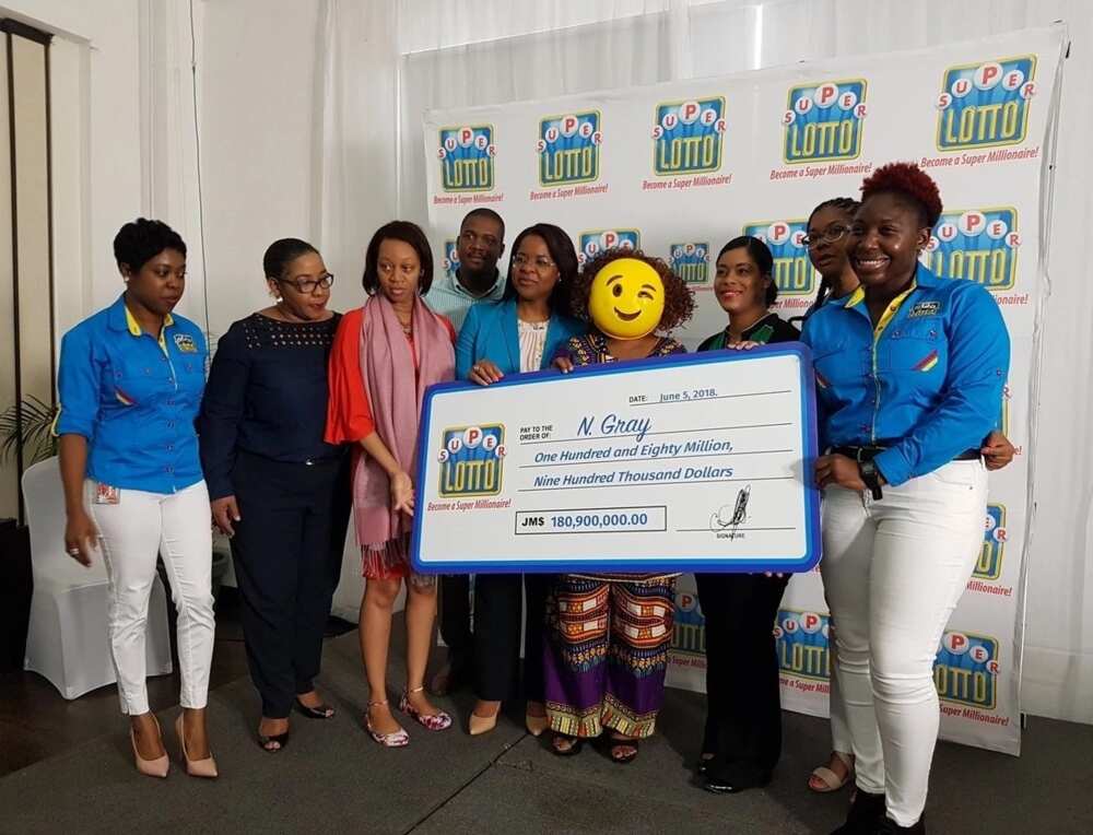 Jamaican lottery winner shows up in mask to claim her $180m prize (photos)