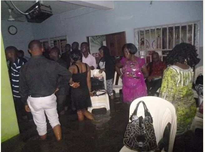 Members of a church worship inside a flooded arena in Port Harcourt