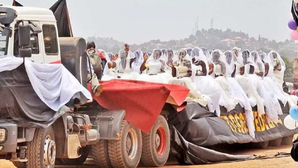 200 brides ride in a truck to their mass wedding in Uganda