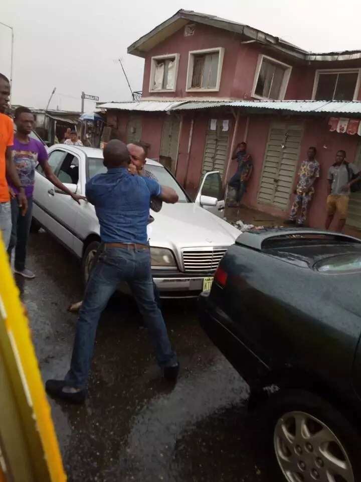 Two men spotted exchanging blows under heavy rain