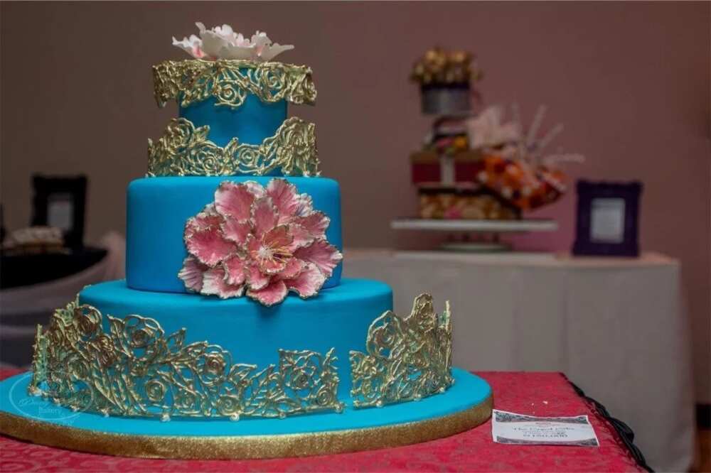 Wedding anniversary cake decorated with flowers and golden lace