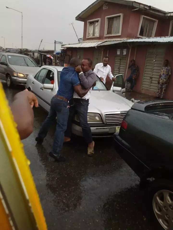Two men spotted exchanging blows under heavy rain